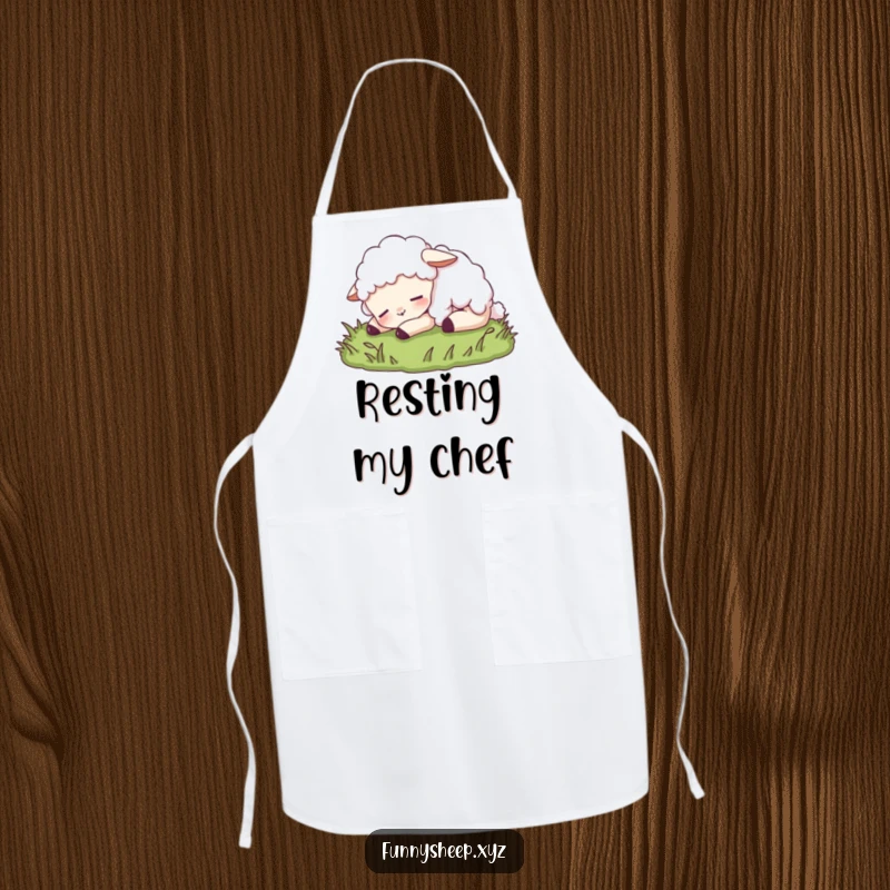 Funny sheep apron featuring a content sheep character peacefully napping on grass, perfect for relaxed cooking and kitchen protection.