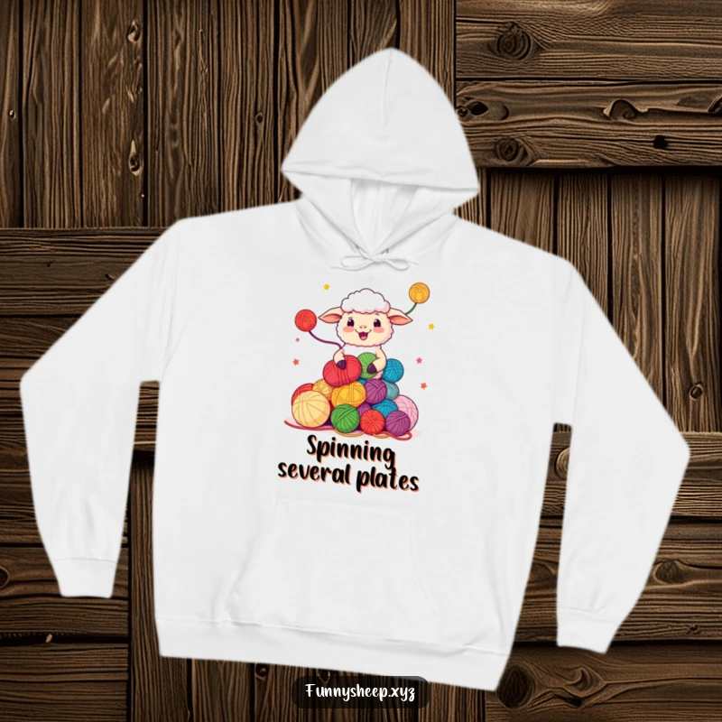 Funny Sheep Hoodie featuring a character juggling colorful yarn balls, cozy and humorous apparel, ideal funny gift.